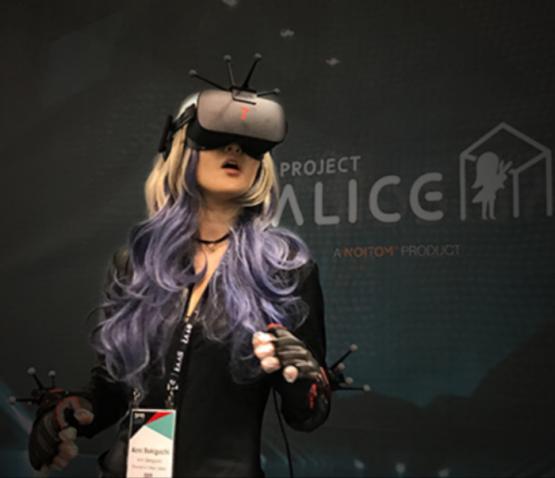 A Japanese influencer wears goggles at the Alice Space virtual reality experience by Noitom at SVVR 2017.